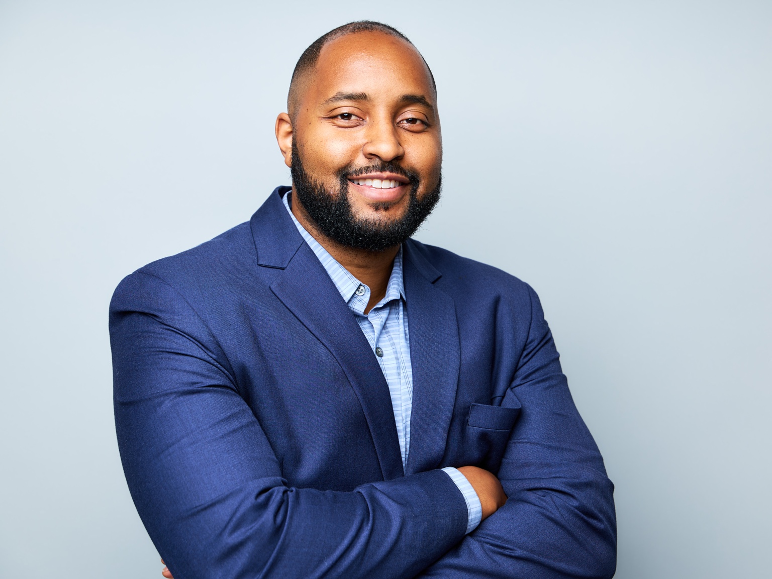 TJ Keys smiling in a blue jacket